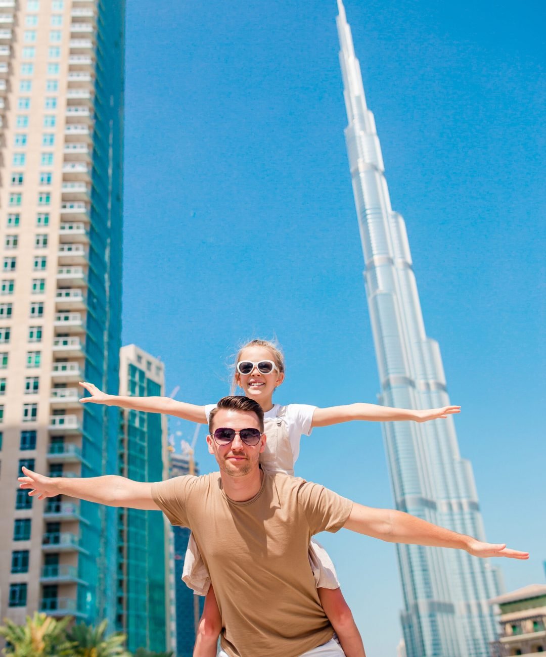 Family of dad and little kid in Dubai in popular sights having fun