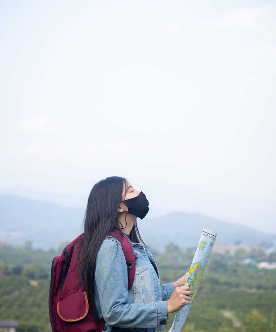 traveler girl searching right direction on map
